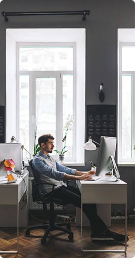 Designer working at a sunlit desk