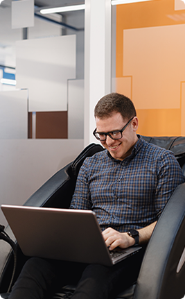 Developer smiling at a laptop in the office