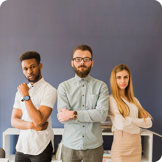 Three team members standing together in the office