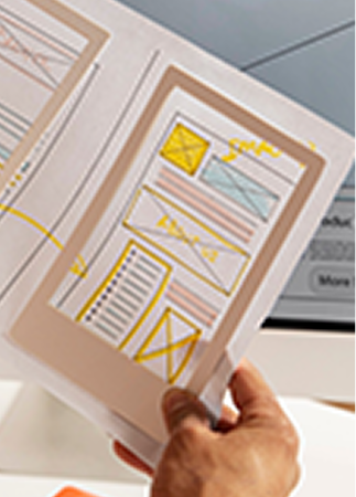 Printed wireframes held up for review